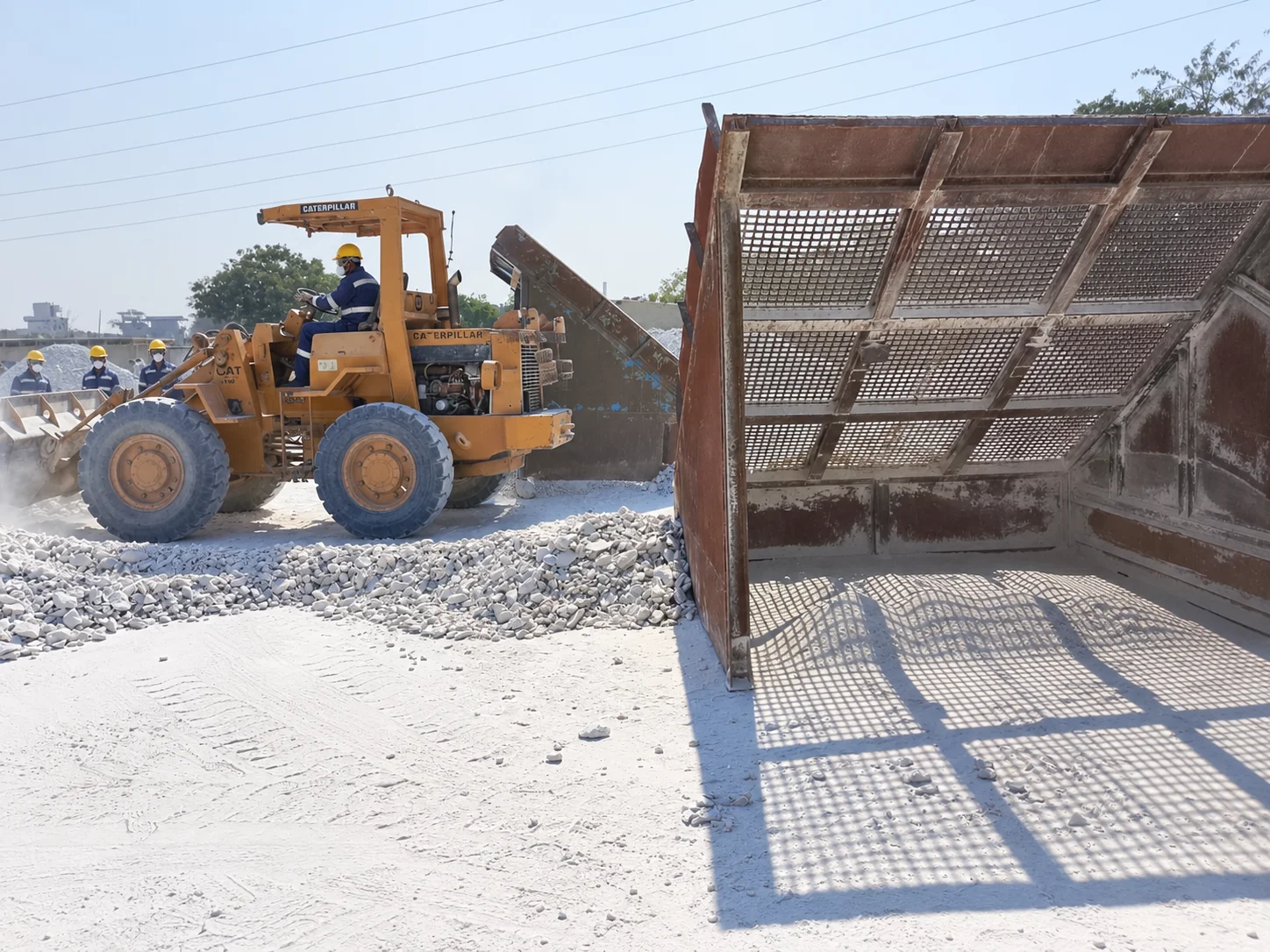 Loader beside mineral screening equipment